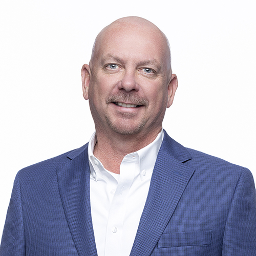 Portrait of Chris Pelton, Antique Brick & Block team member, smiling in a blue sport coat